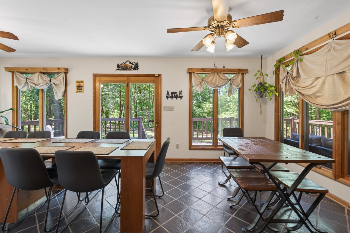 Dining Room: Bright and airy space with forest views, perfect for gatherings over delicious meals!