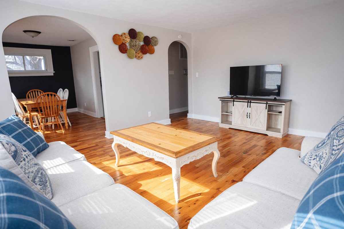 Kick back on the comfy couch, put your feet up on the coffee table, and enjoy your favorite shows on the smart TV. It’s a great spot to relax, hang out, and unwind after a long day.