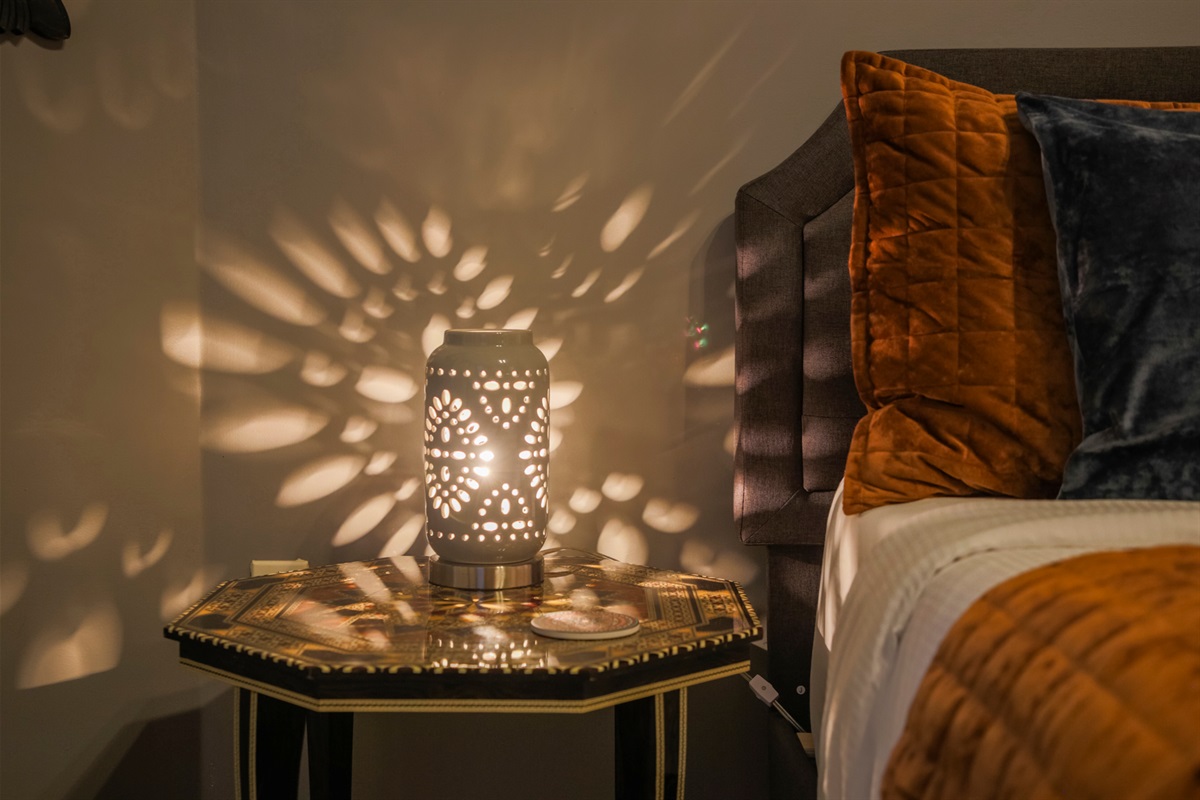 A distinctive lamp adds a touch of personality and charm to the king bedroom.