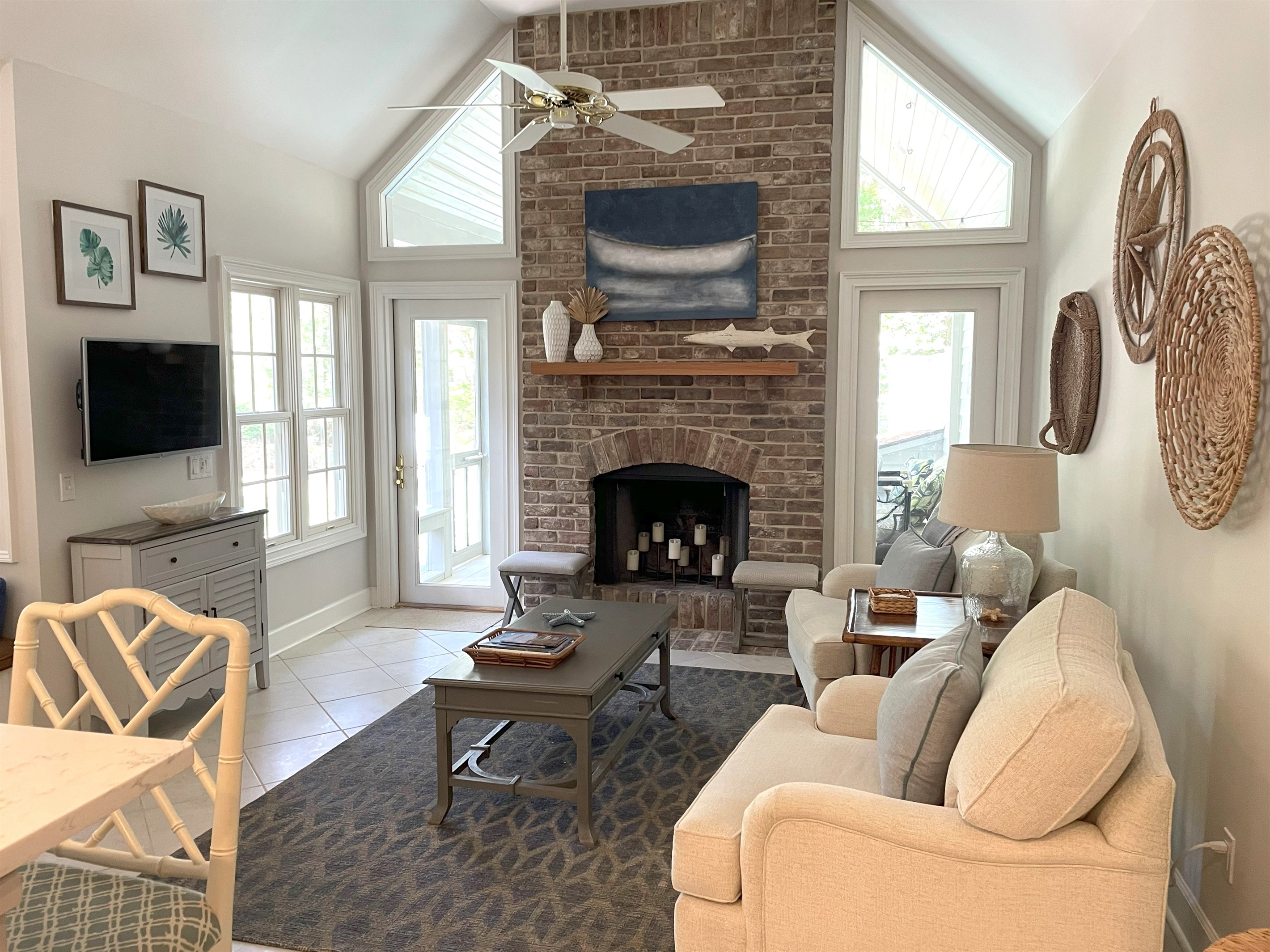 Hearth room with cathedral ceiling and entrance to screen porch
