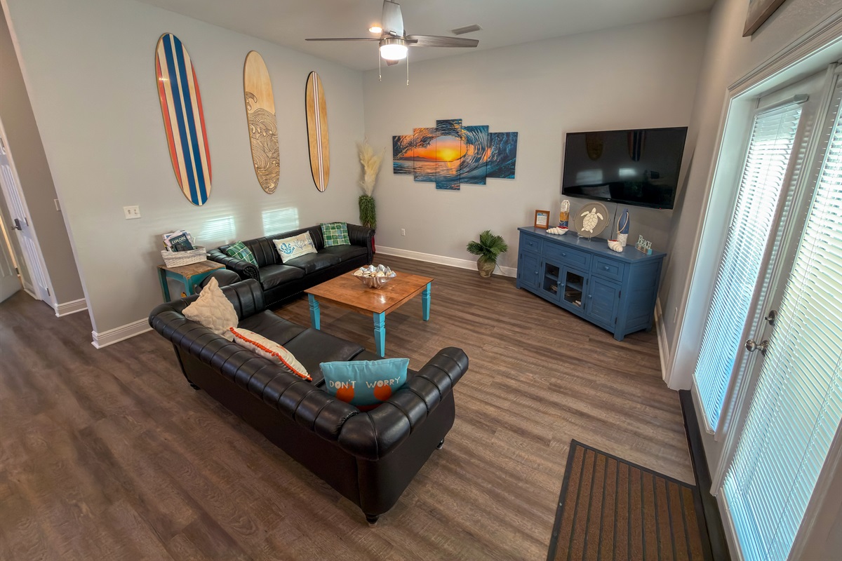 Oversized seating and surf-inspired accents bring a peaceful yet elevated beach-house feel to the living space.