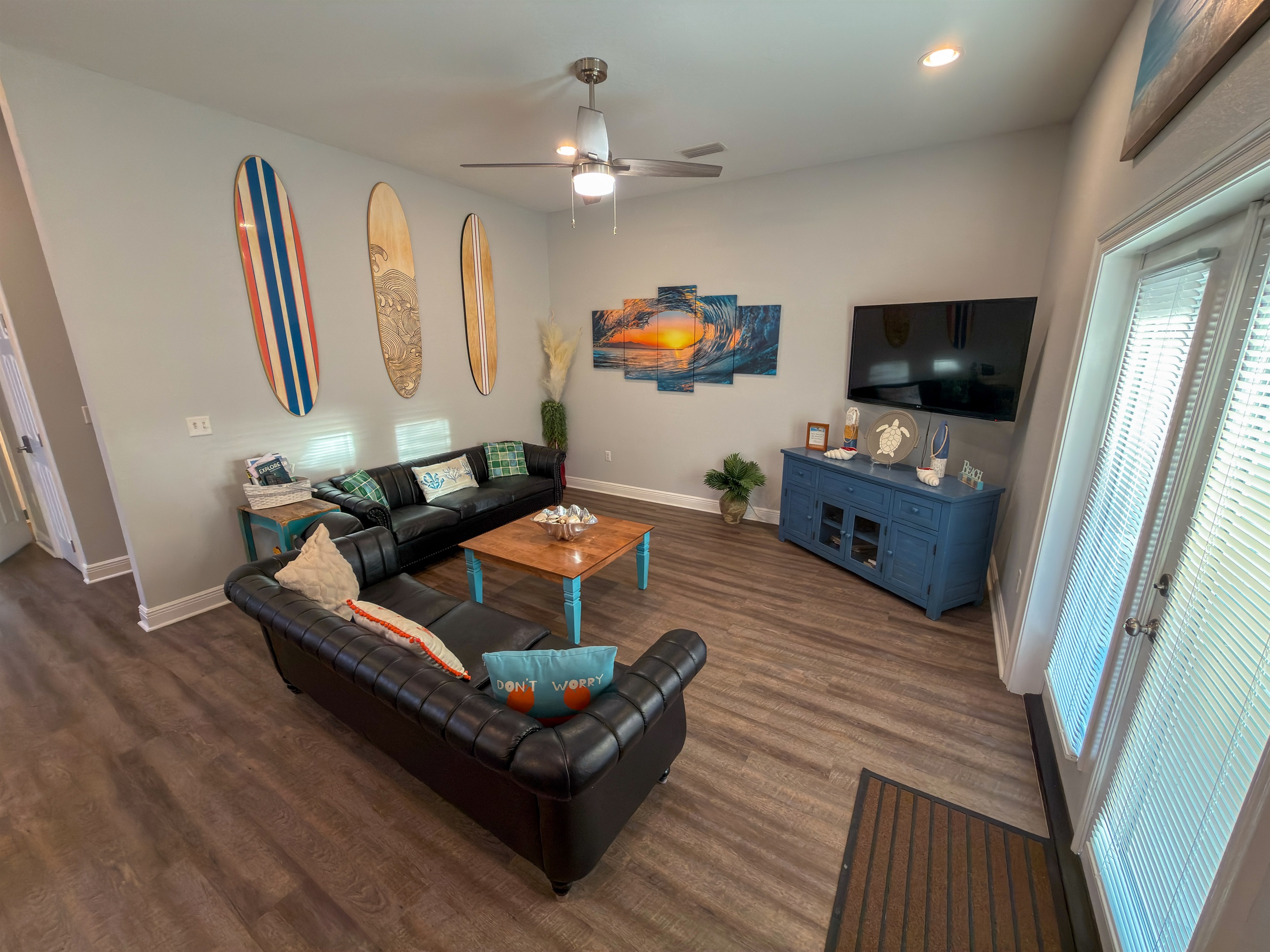 Oversized seating and surf-inspired accents bring a peaceful yet elevated beach-house feel to the living space.