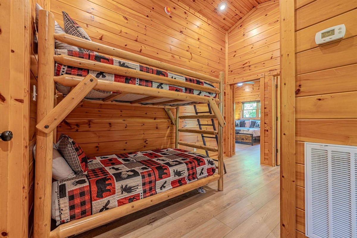 Upper-level bunk area with two twin bunk beds &mdash; sleeps 4 additional guests. Perfect for kids or extra teammates. Gatlinburg group cabin sleeps 12.
