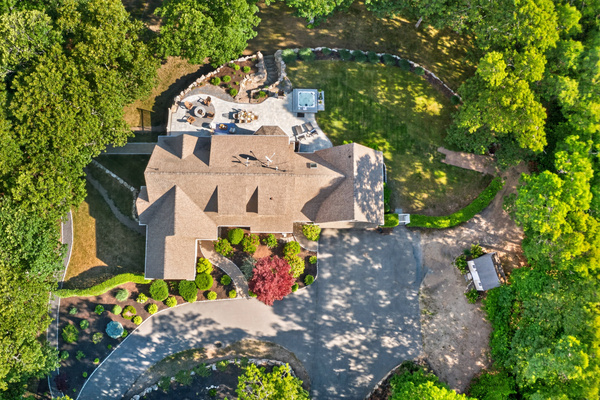 A full layout of lakeside living—grill, firepit, seating, and the water just steps away.