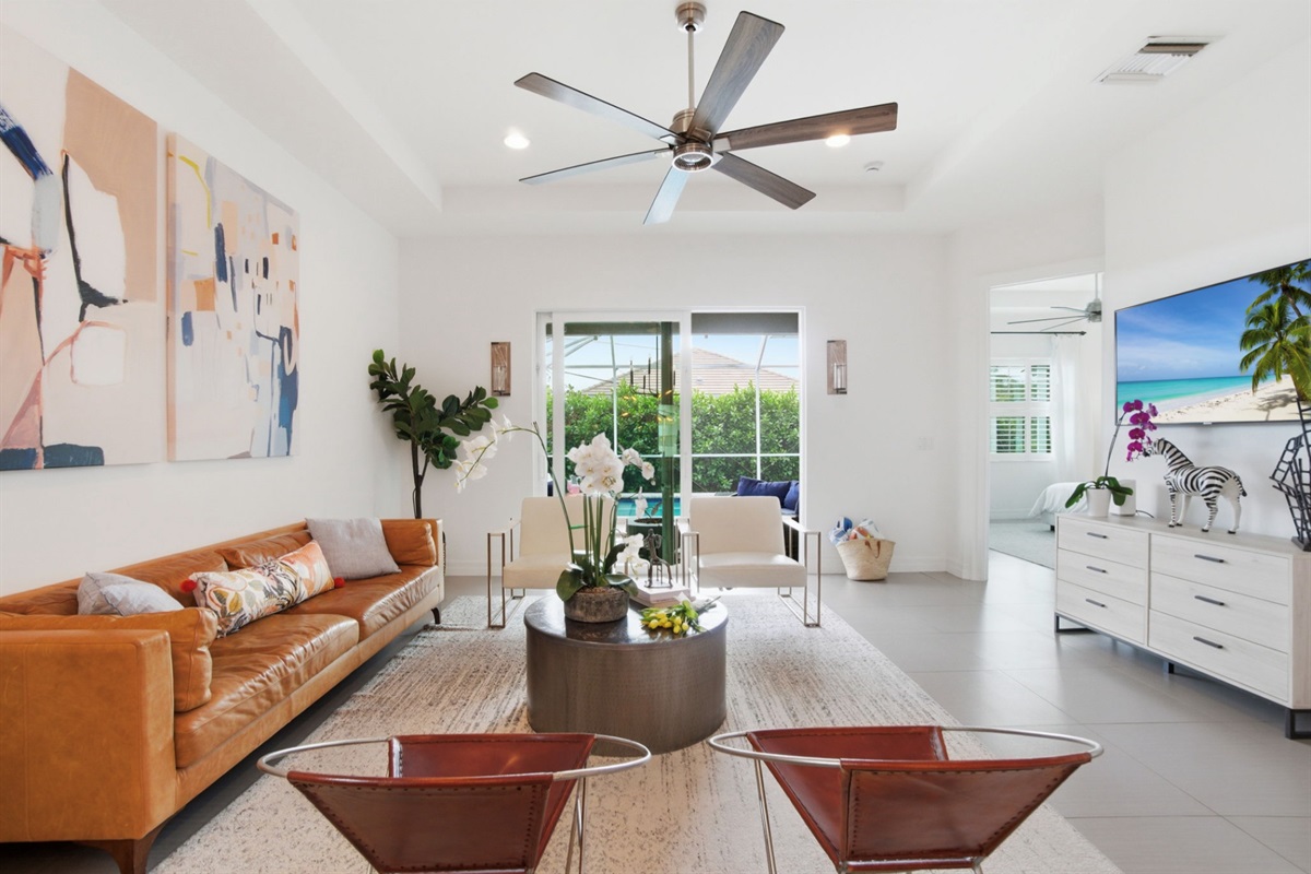 Living room opens to the lanai and screened in pool