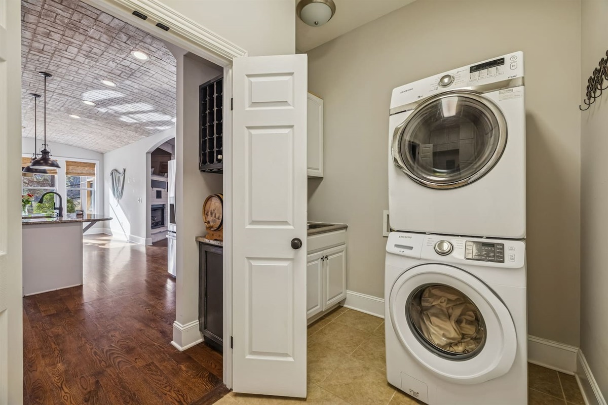 Full laundry room with a great supply of cleaners, vacuum cleaner and other supplies.