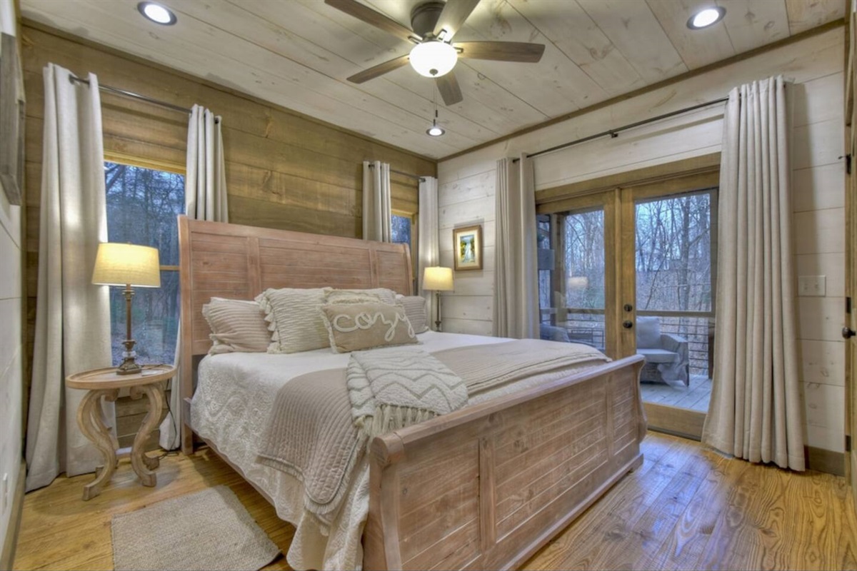 Main floor bedroom has a king bed and closet.  Bedroom also has doors to enter the deck level with fireplace, sitting area, swing, and dining area.