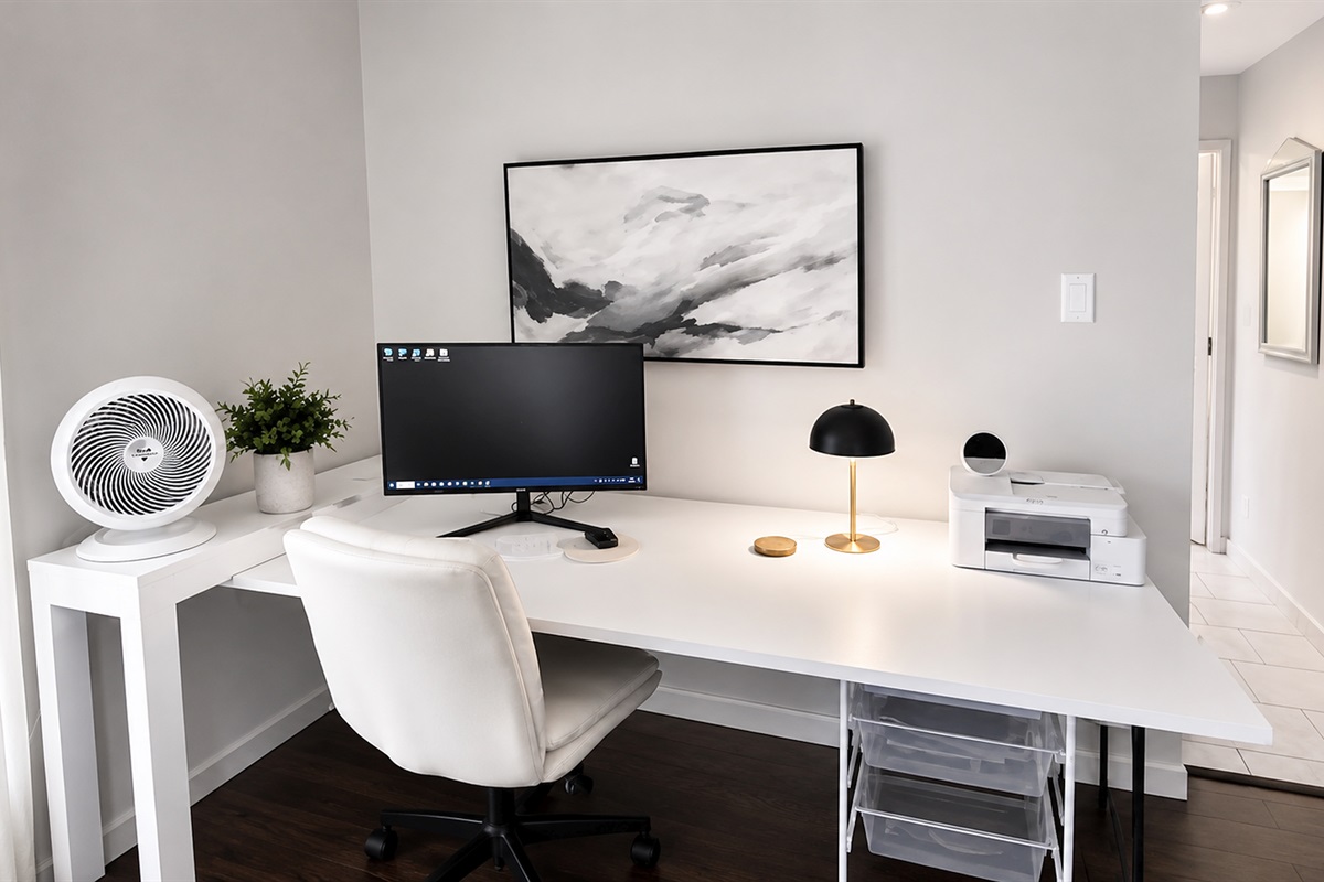 Dedicated workspace with desk setup, monitor, and printer — ideal for remote work or longer stays