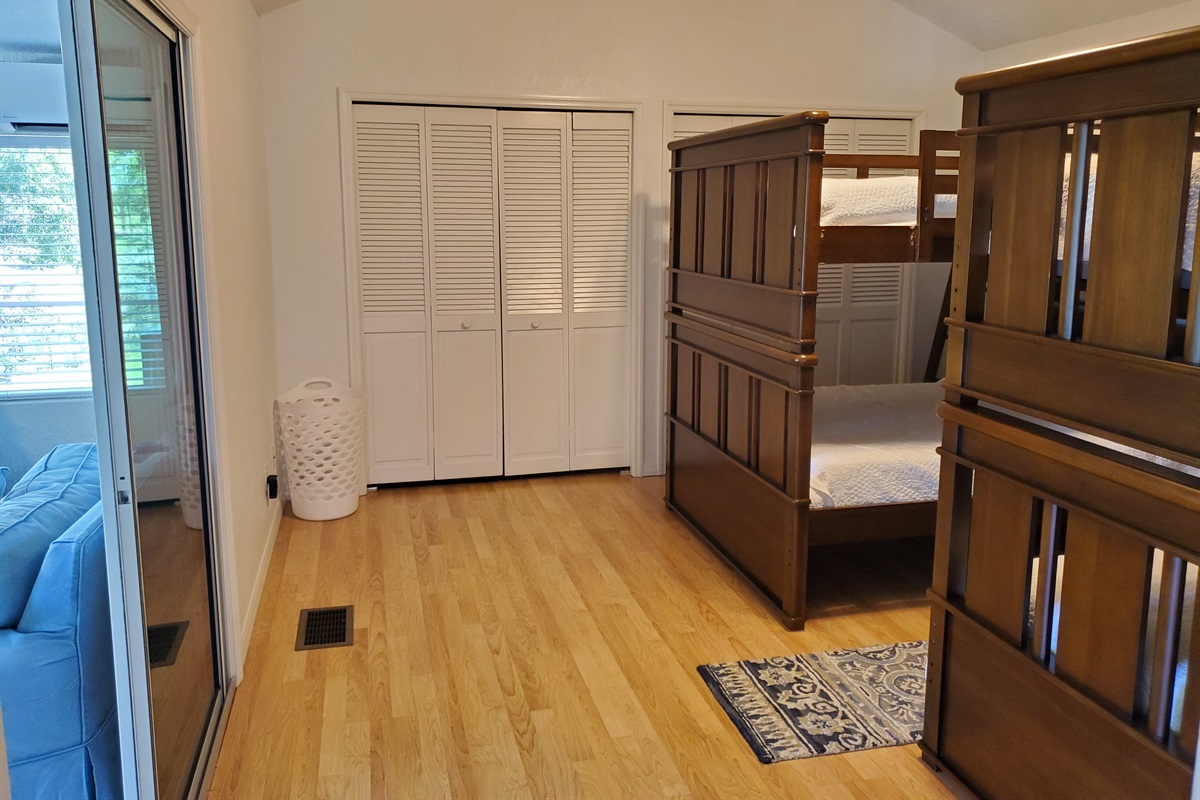Lounge on left side of bunkbed room with a Smart TV/game room.