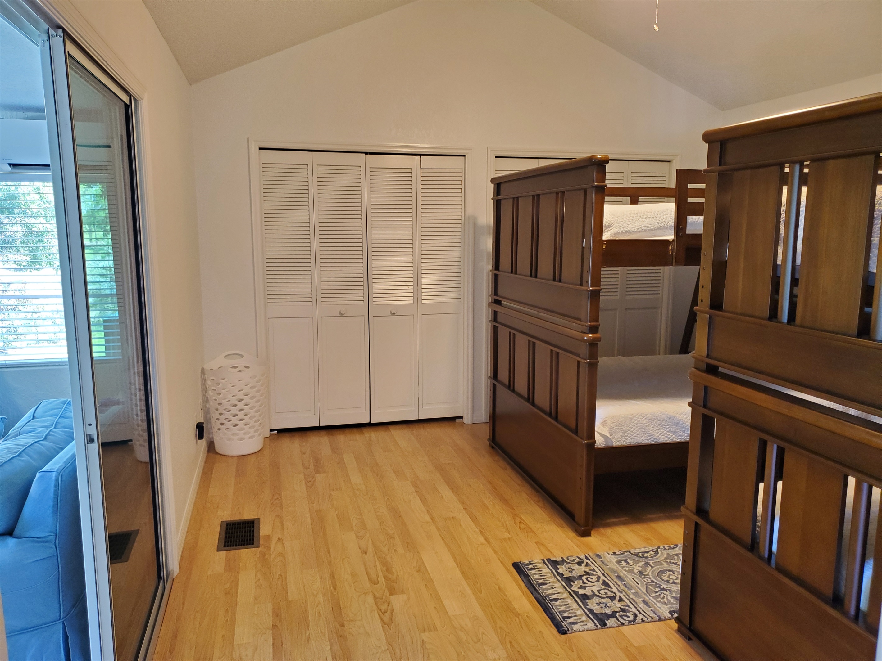 Lounge on left side of bunkbed room with a Smart TV/game room.