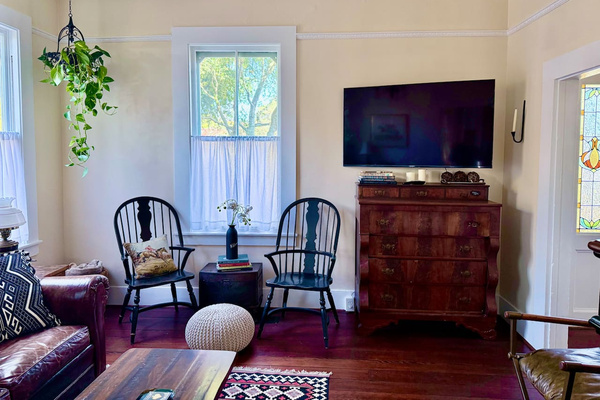 Old soul, modern comforts. The light-filled living room pairs antique furnishings with a Smart TV on a movable arm, so every seat works. Games and cards are tucked into the dresser for evenings when everyone is ready to unplug.