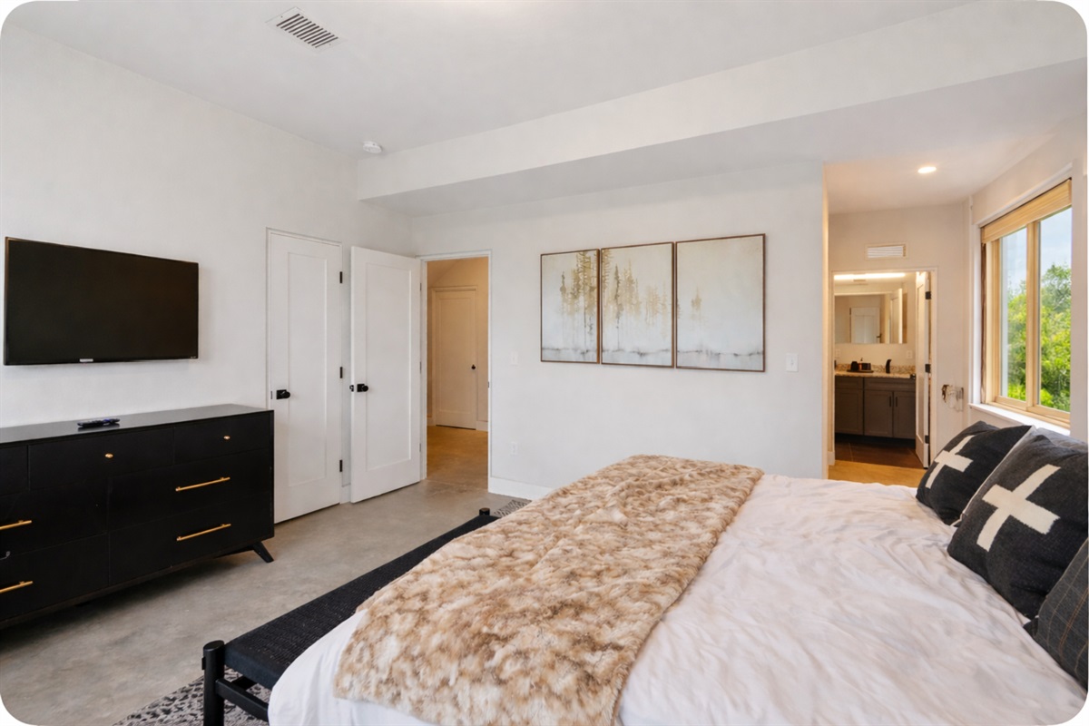 Primary bedroom king room has ample space creating a luxurious comfortable feel
