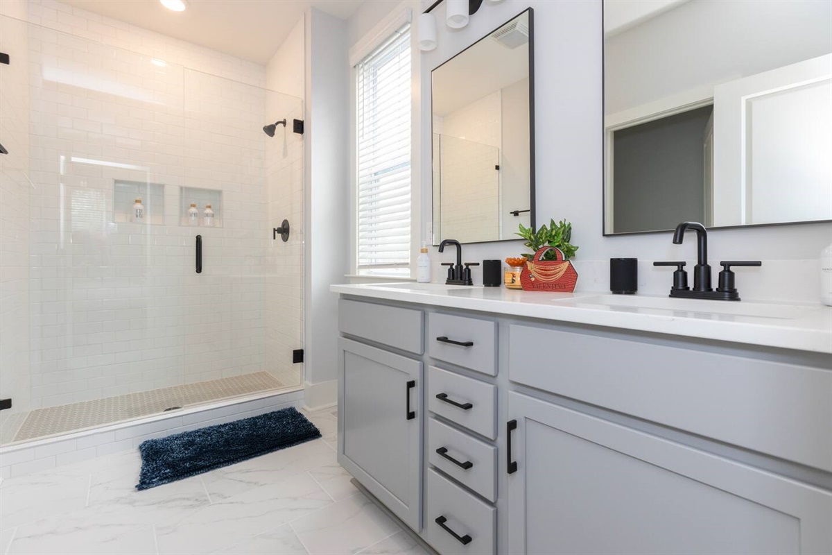 The primary ensuite bathroom has a double vanity, walk-in shower, and private bathroom with toilet.