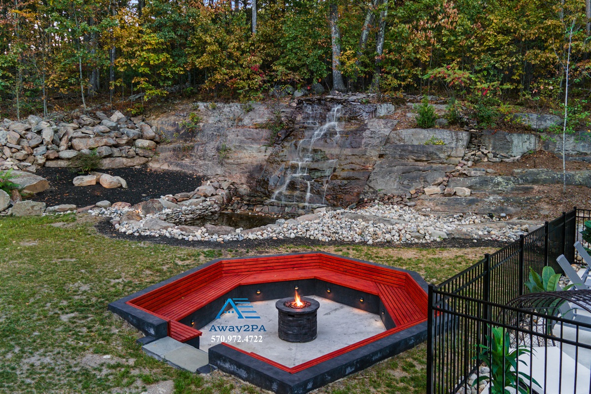 Recessed firepit by waterfall