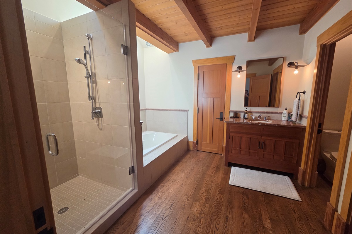 The carriage house includes its own private bathroom, separate from the main house, with a soaking tub and a large walk-in shower for added comfort.