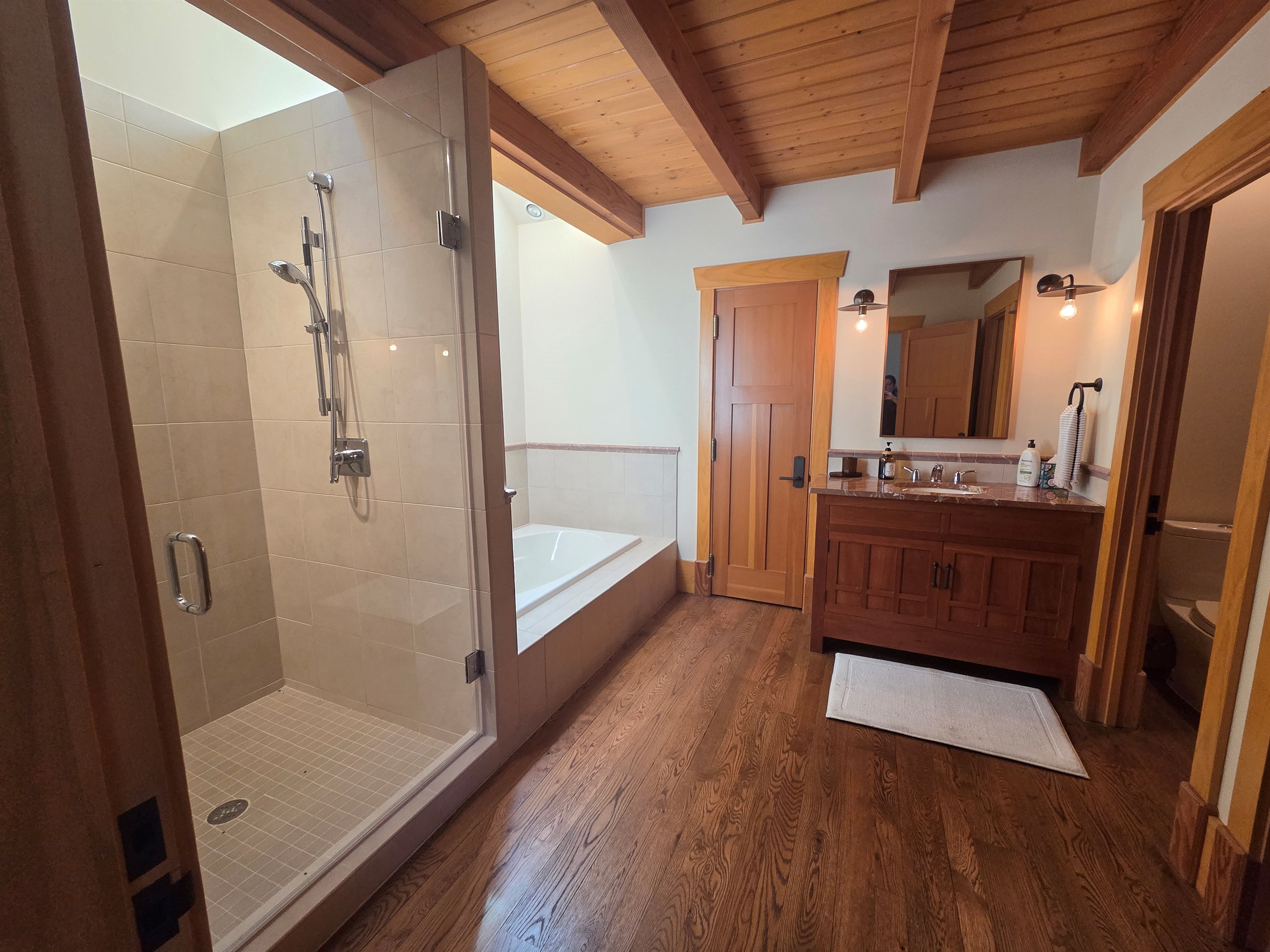 The carriage house includes its own private bathroom, separate from the main house, with a soaking tub and a large walk-in shower for added comfort.