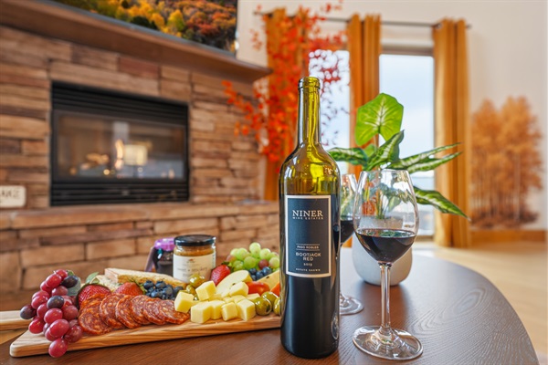 A glowing fireplace anchors the room, inviting you to sink into plush seating with a glass of wine or a good book.