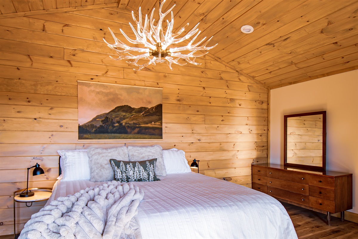 Relax in a spacious primary suite while you take in a wall of mountain views! Dancing pole for extra fun.