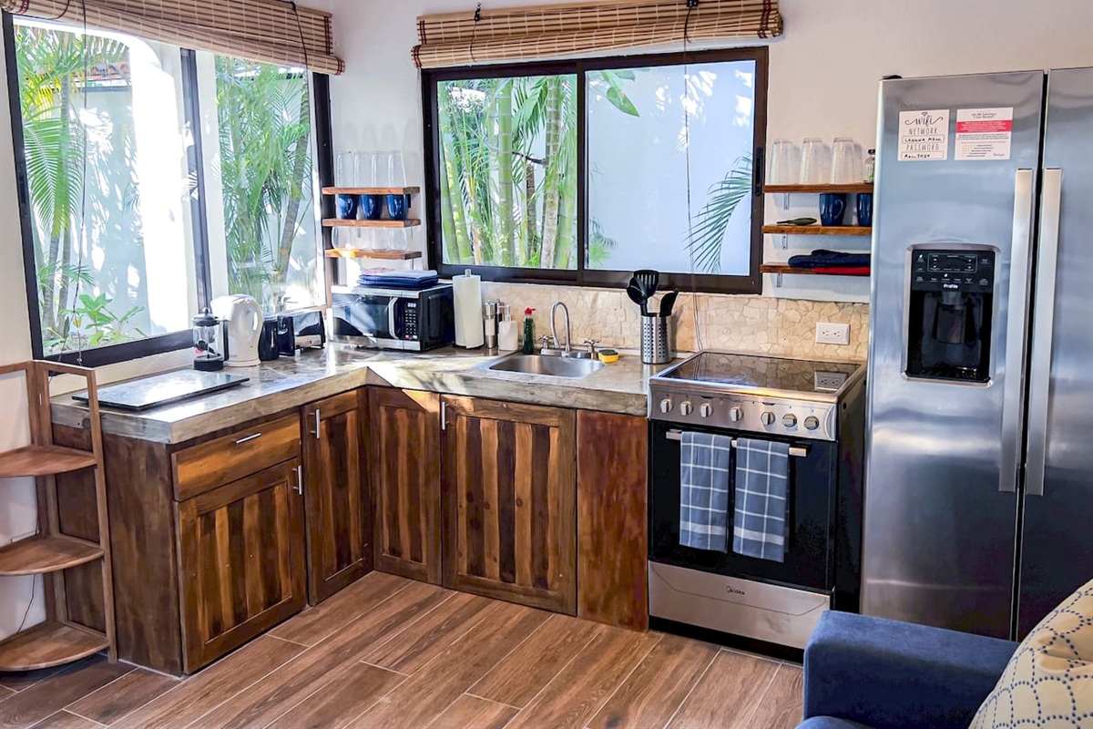 The well stocked kitchen has everything you need... full oven, fridge with ice maker, microwave, sink, French Press and kettle.  