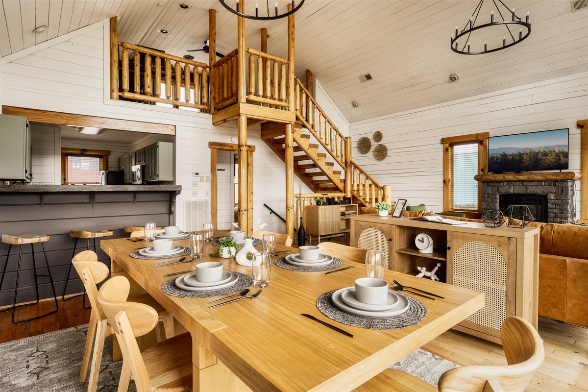 Gather 'round our inviting dining table seamlessly flowing into a cozy bar counter, where every meal becomes a shared moment of warmth and connection.