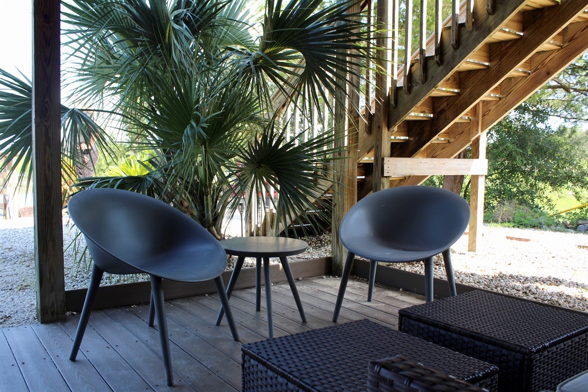 Extra outdoor living space, tucked under the home and surrounded by palms—ideal for relaxing after a day on the water.