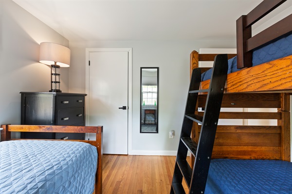 The second bedroom’s twin and bunk beds create a warm, inviting space for all ages.