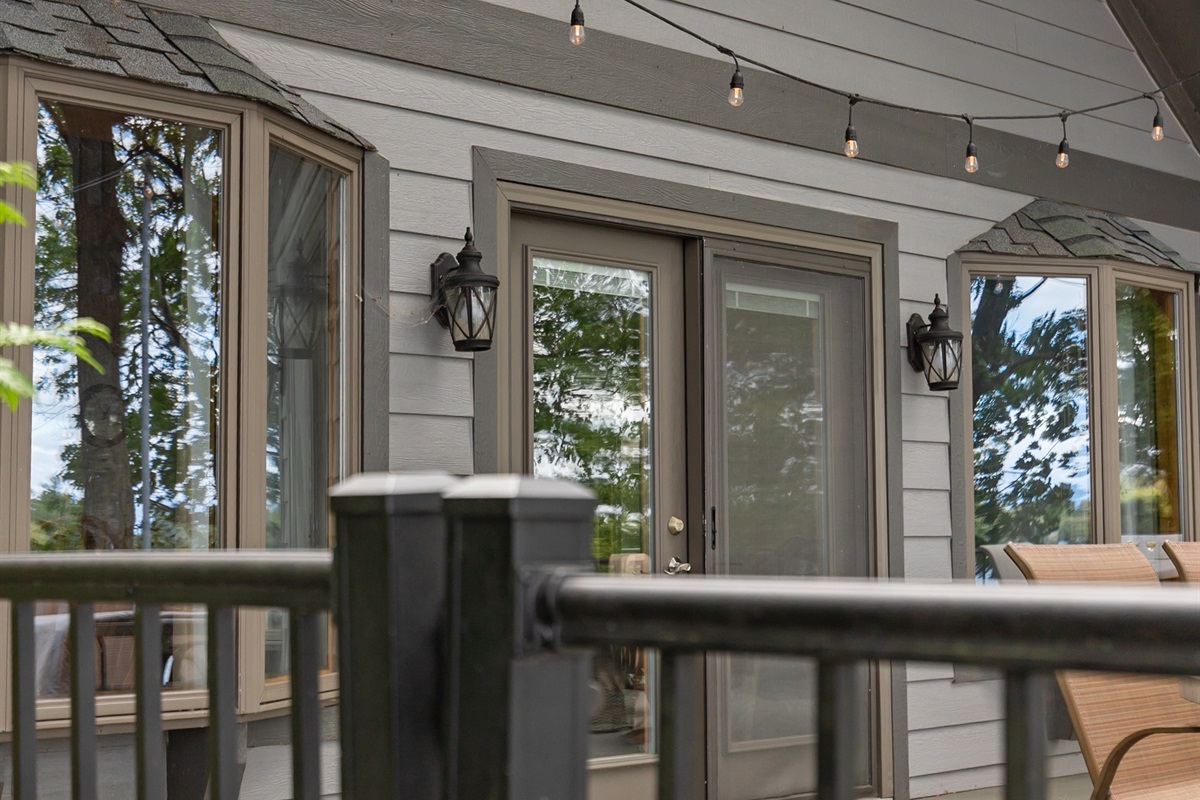 Patio doors open wide to bring the indoors out—seamlessly blending comfort with fresh lake air.