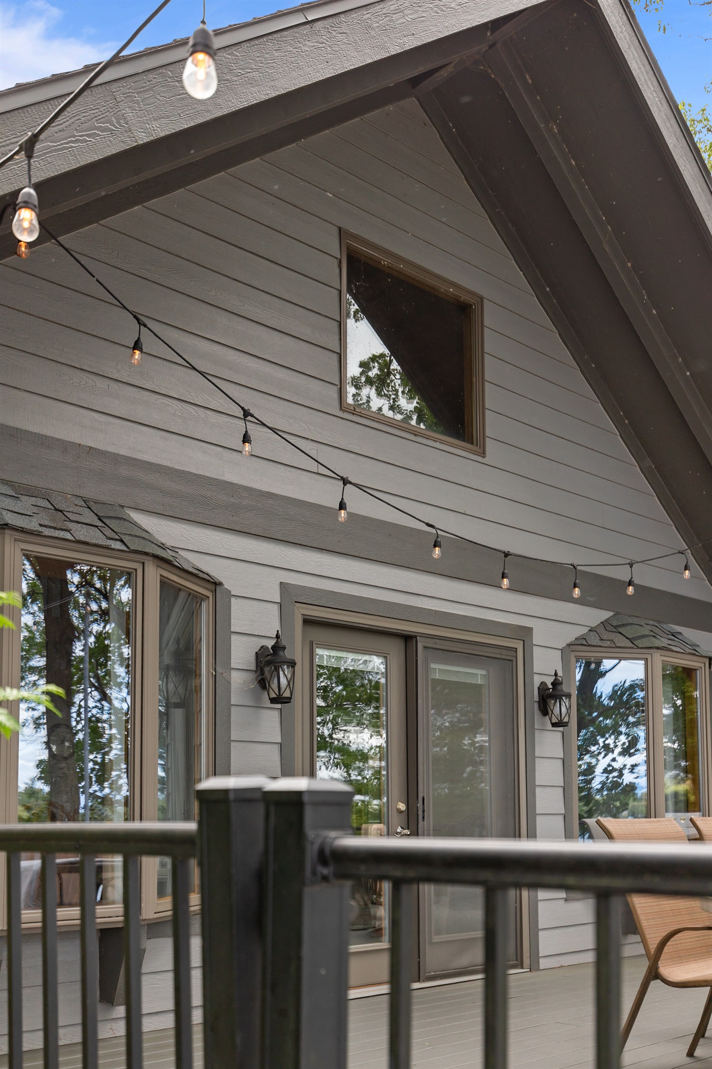 Patio doors open wide to bring the indoors out—seamlessly blending comfort with fresh lake air.