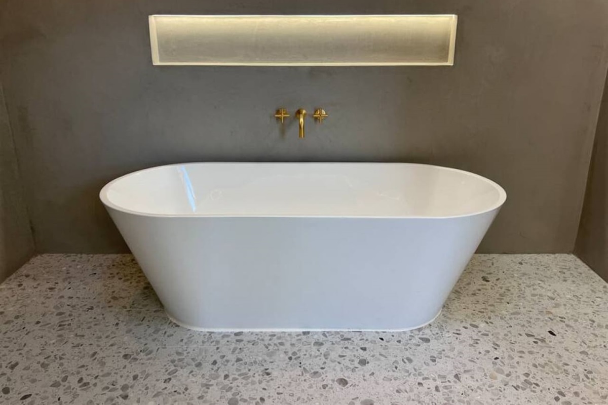 The primary suite has a new 120 sq ft private spa bathroom that is done in Moroccan plaster (walls) and Italian terrazzo (floors). It includes this 71" soaking tub and two showerheads.