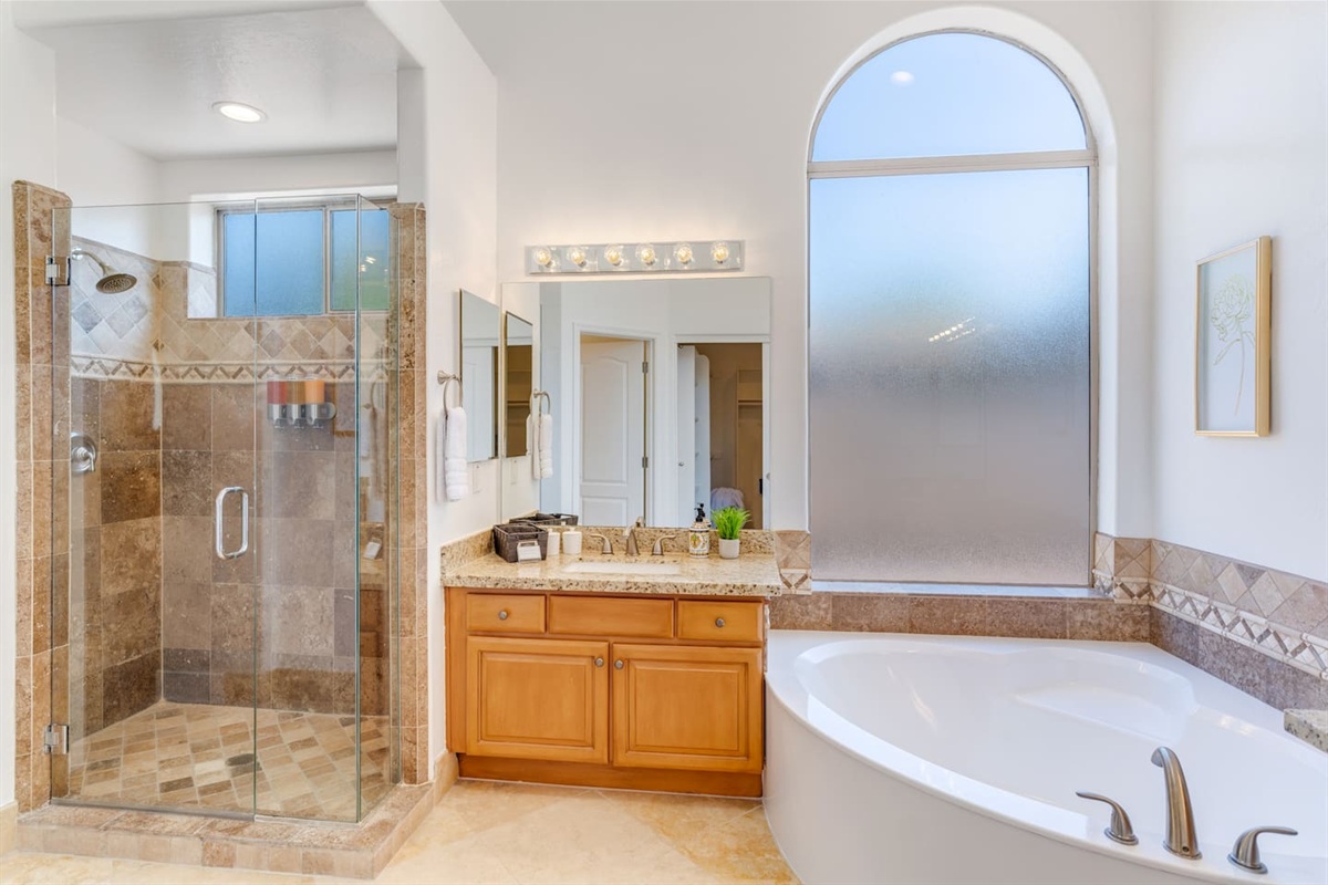 Walk in tile shower with shampoo, conditioner and body wash for your use. Also, individual sinks in the primary bath.