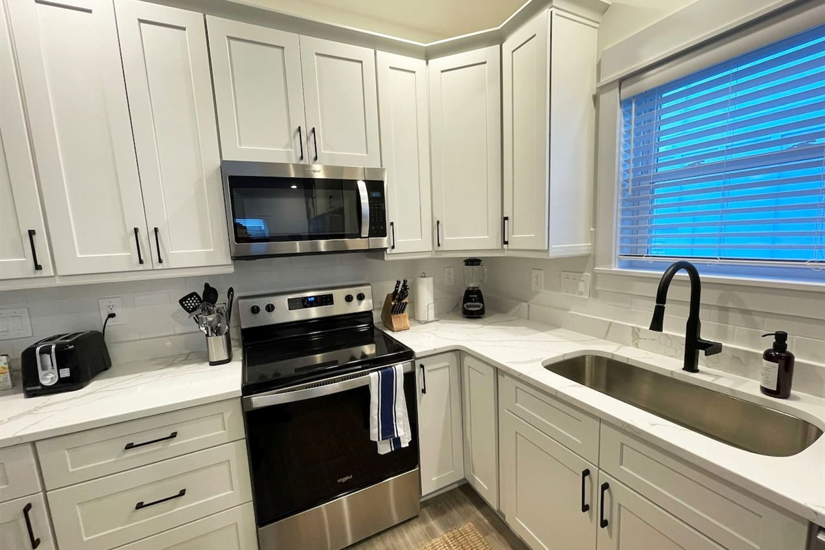 This thoughtfully equipped kitchen offers everything needed for preparing meals during your stay, including ample counter space and modern appliances.