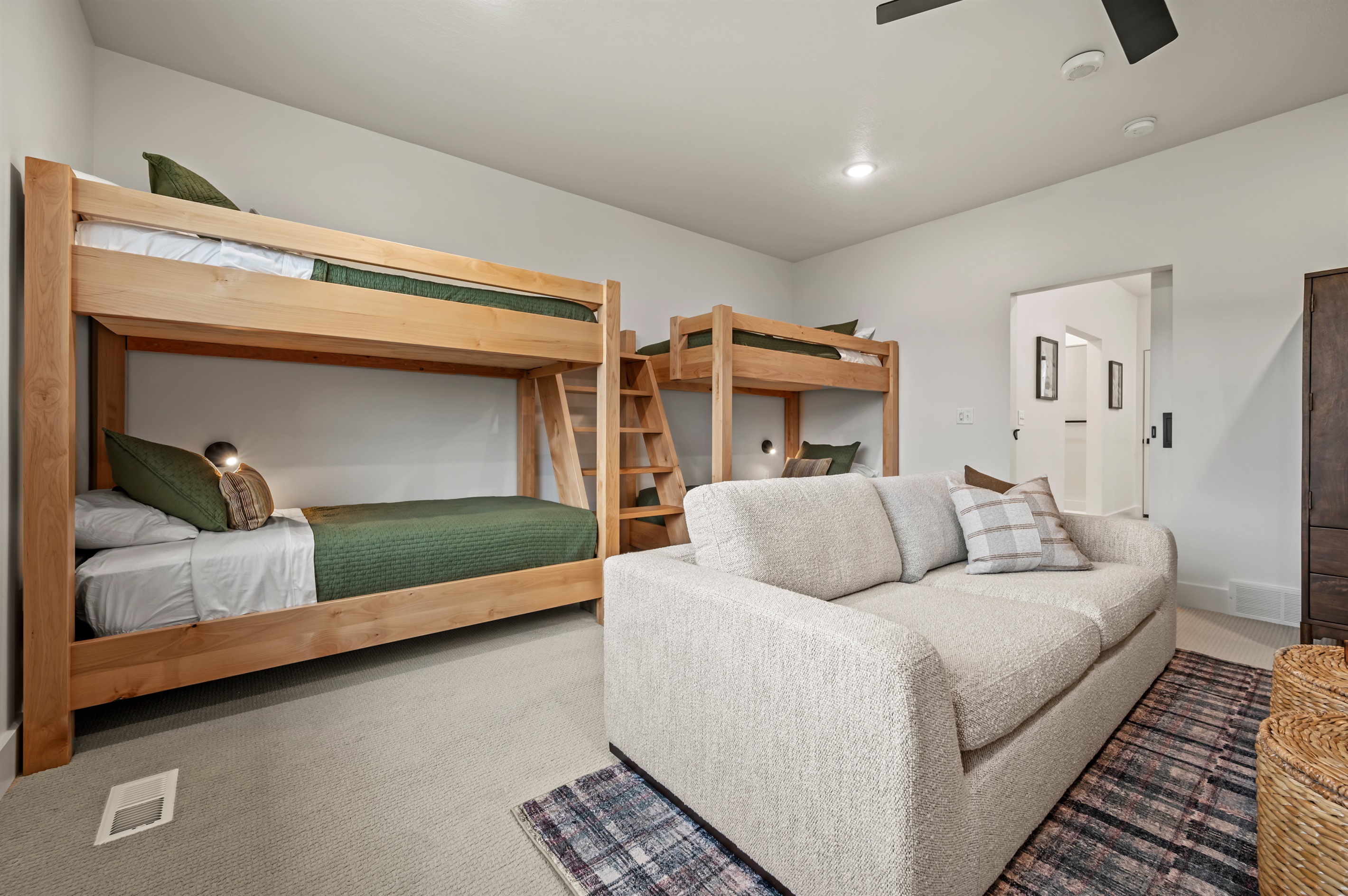 This room offers plenty of sleeping space with two twin-over-twin bunk beds, plus a comfy sofa for lounging.
