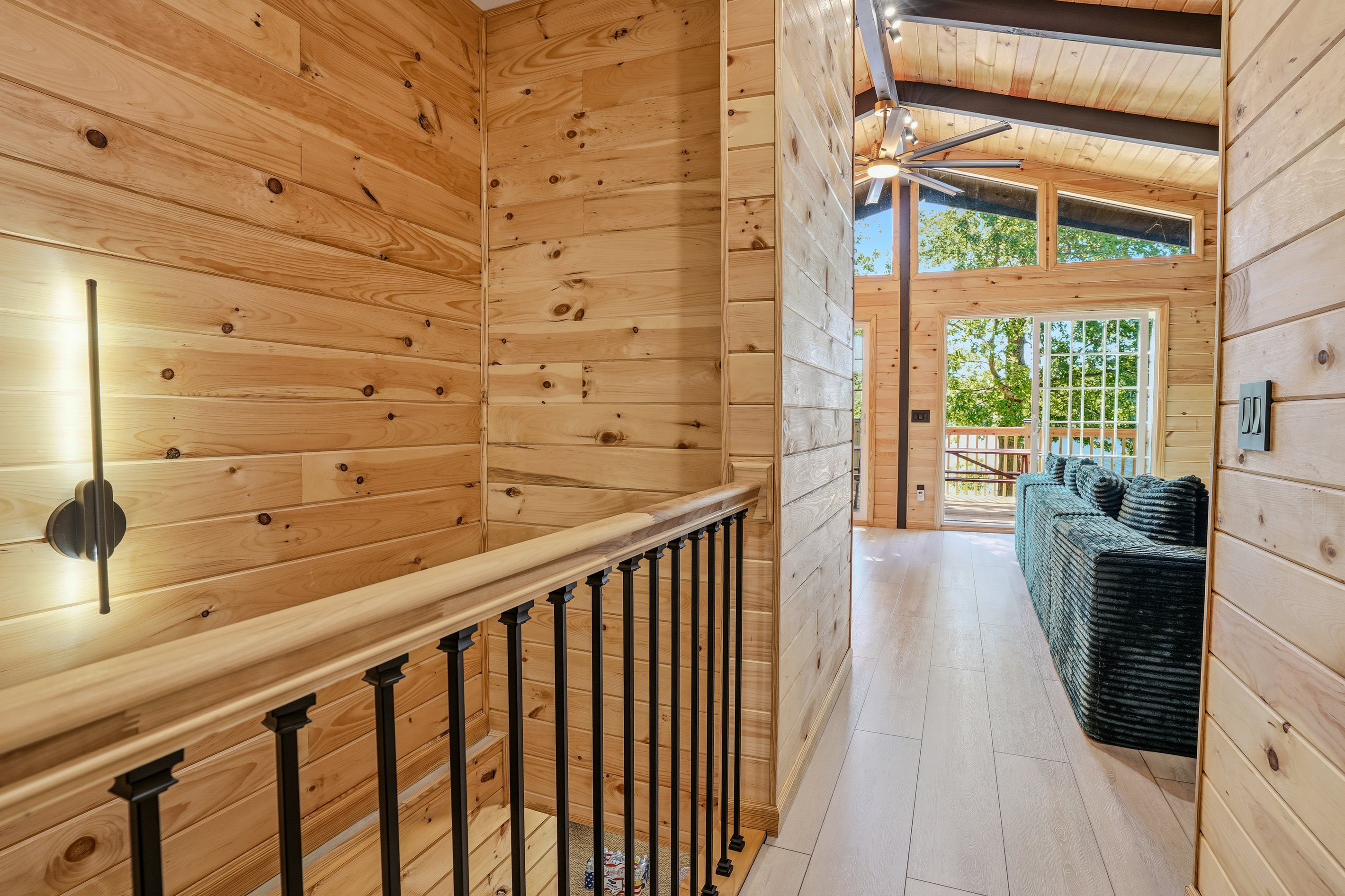 Upper-level landing with open staircase and sightline down to the main living area