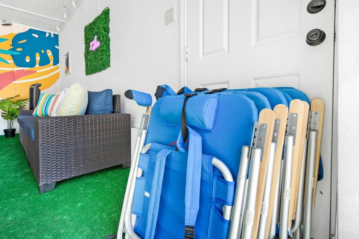 Beach chairs stacked and ready by the door, part of the gear we leave for you along with towels and an umbrella. Grab four on your way out and the three-minute walk to the sand is all you have to manage.