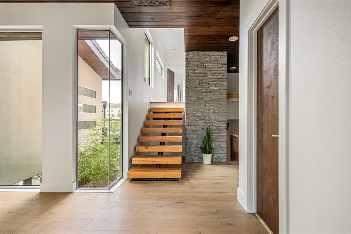 Bright stair landing with floor-to-ceiling windows