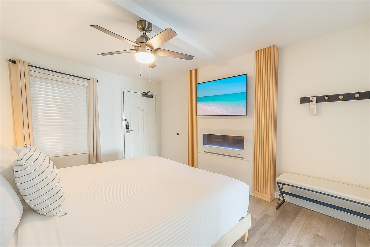 Modern with crisp clean white linens and fireplace. 