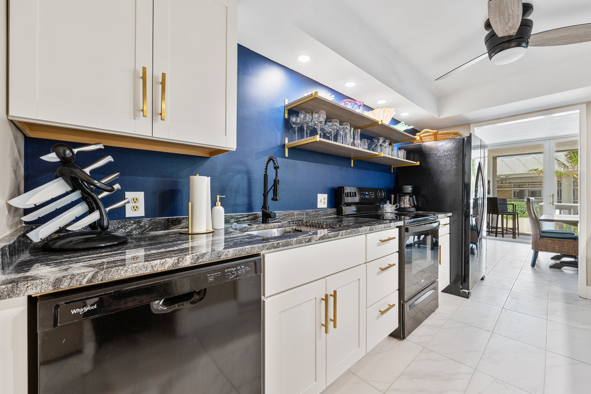 Fully stocked kitchen with cookware, plates, utensils, and all your dining essentials — plus a refrigerator with built-in ice maker and water filter.
