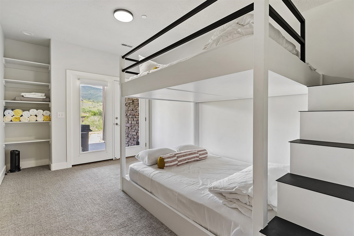 Perfectly designed for comfort and style, this chic bunk room features custom queen-over-queen beds—an inviting retreat ideal for families or group stays.