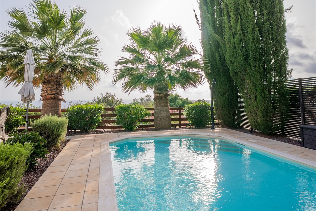 Enjoy a refreshing dip in the large swimming pool, newly refinished with easy-access staircase and extra-high skimmers. Solar-heated shower for rinsing off. Pool heating is available during the cooler months for an added fee, ensuring year-round comfort.