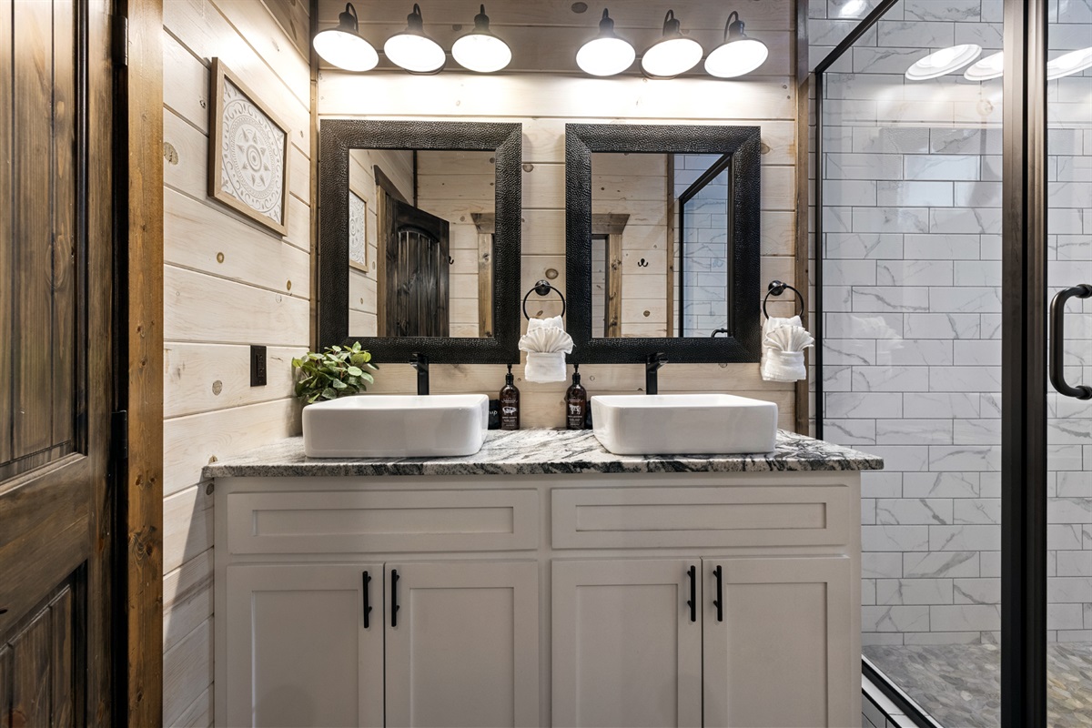 A light and airy bathroom with rustic details and everything you need for a refreshing stay in the bunkhouse bathroom!