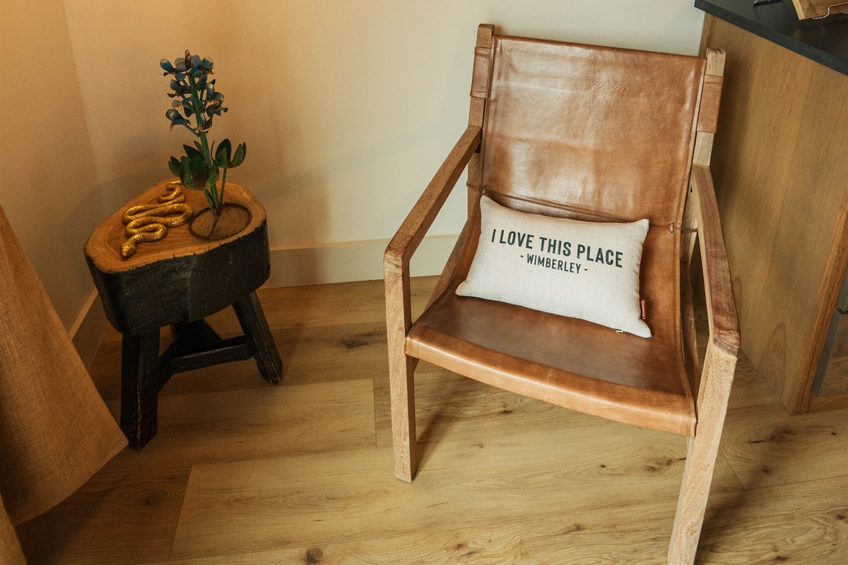  A warm welcome inside the Corral Suite — a handcrafted seating corner and thoughtful Hill Country touches at Gaines Ranch on the Square.