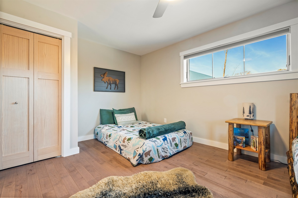 Spacious bedroom for kids or multi-family stays with bunk bed and double bed.