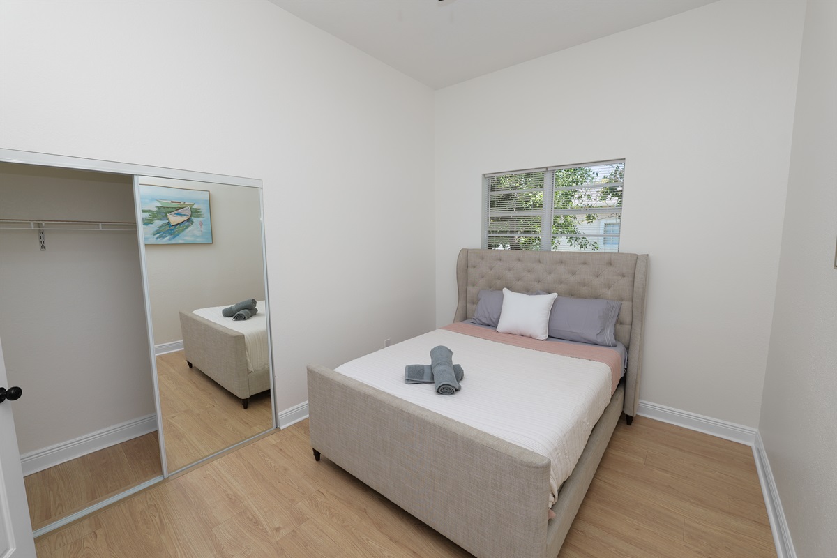 A sophisticated upholstered bed anchors this peaceful retreat—ideal for curling up with a book or getting a great night’s sleep.