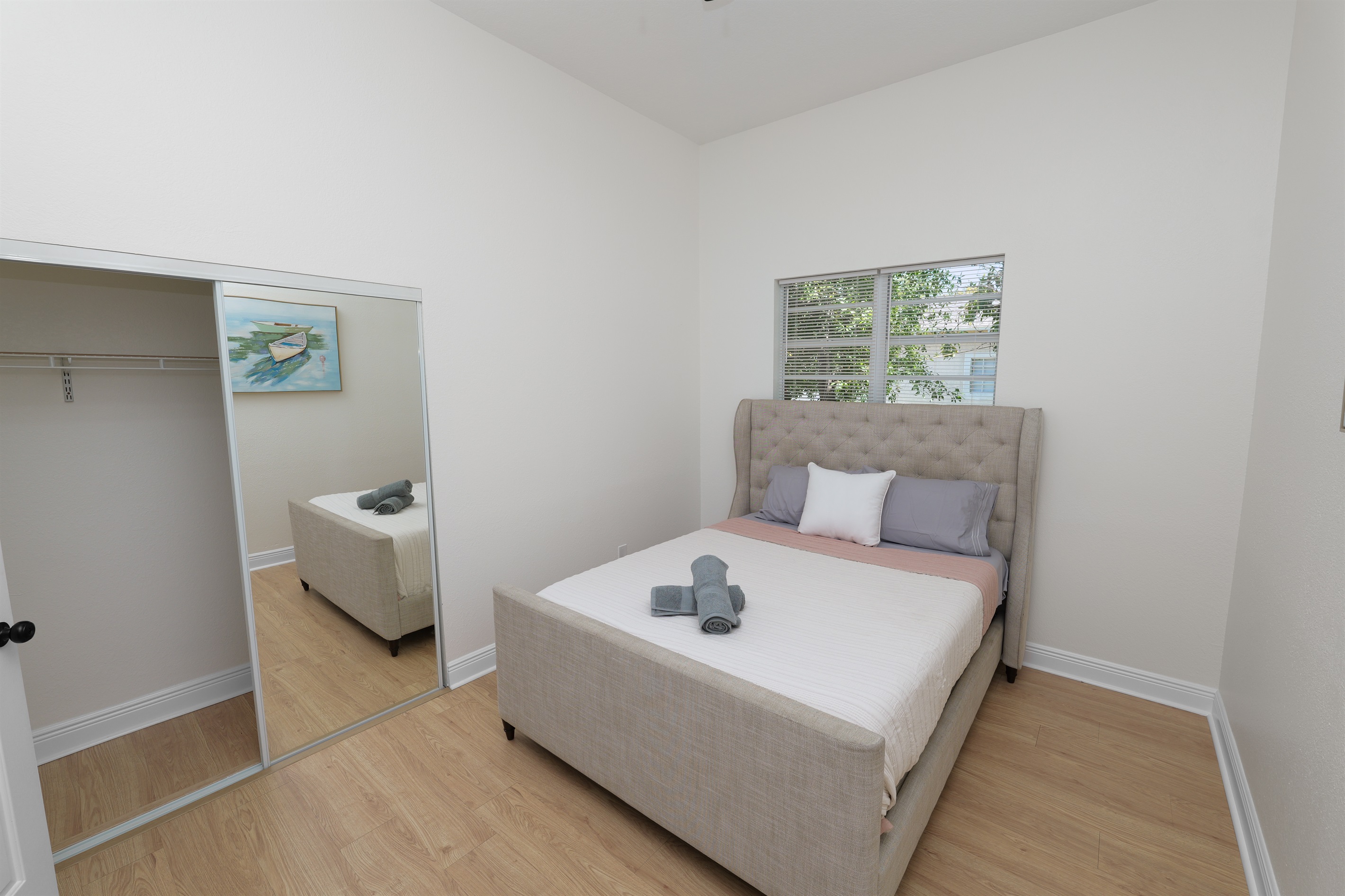 A sophisticated upholstered bed anchors this peaceful retreat—ideal for curling up with a book or getting a great night’s sleep.