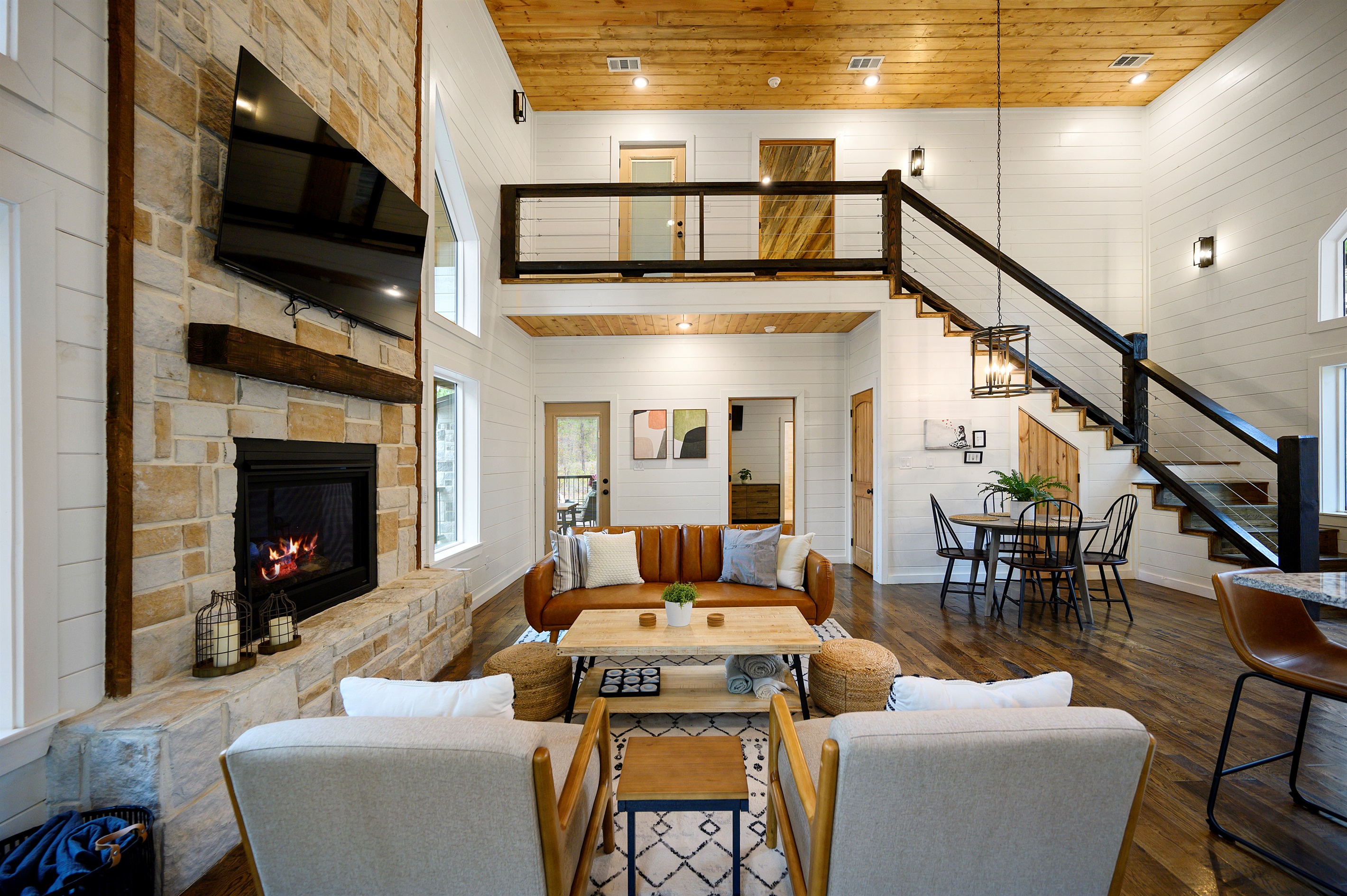 The heart of Hit Refresh, where cozy cabin moments naturally come together. 
A glowing fireplace, soaring ceilings, and open spaces designed for movie nights, slow mornings, and memory making with your favorite people.