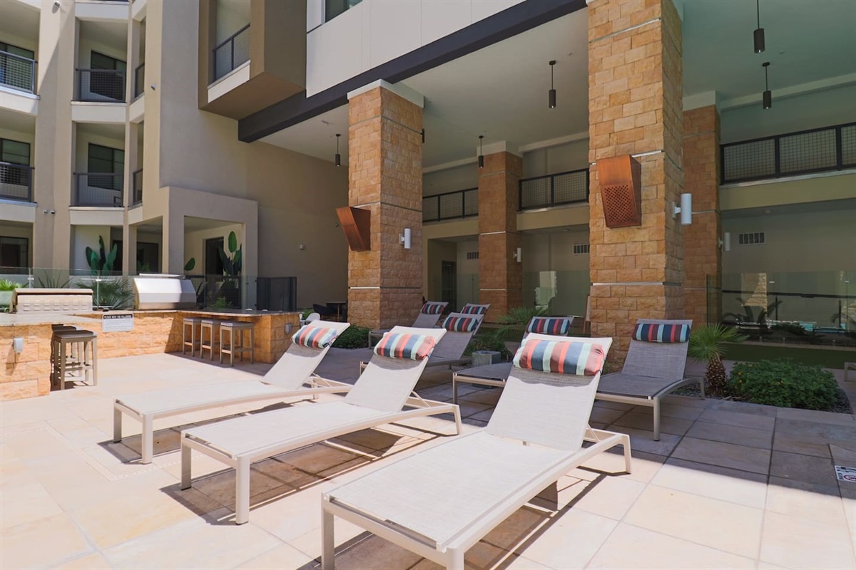 - Soak up the sun on poolside loungers with stylish cushions and open views   - Relax near the outdoor BBQ area for a refreshing, laid-back afternoon   - Ideal for tanning, reading, or simply enjoying the peaceful poolside air