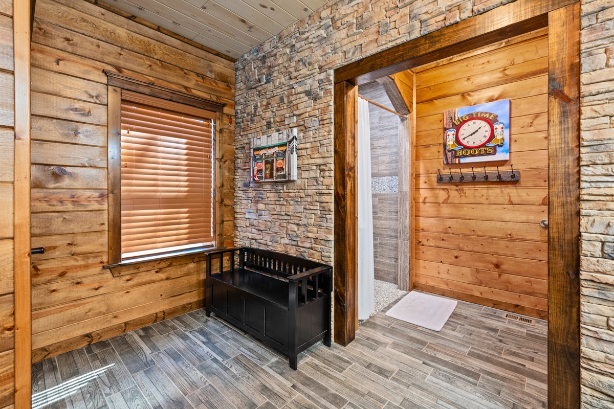 This bathroom space continues the clean and cohesive design with warm finishes and easy access from nearby rooms, offering both comfort and convenience for guests using this shared area.