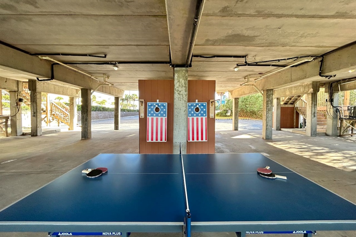 Fun-filled game time on a one-of-a-kind, patriotic-themed ping pong table with paddles in a vibrant space.
