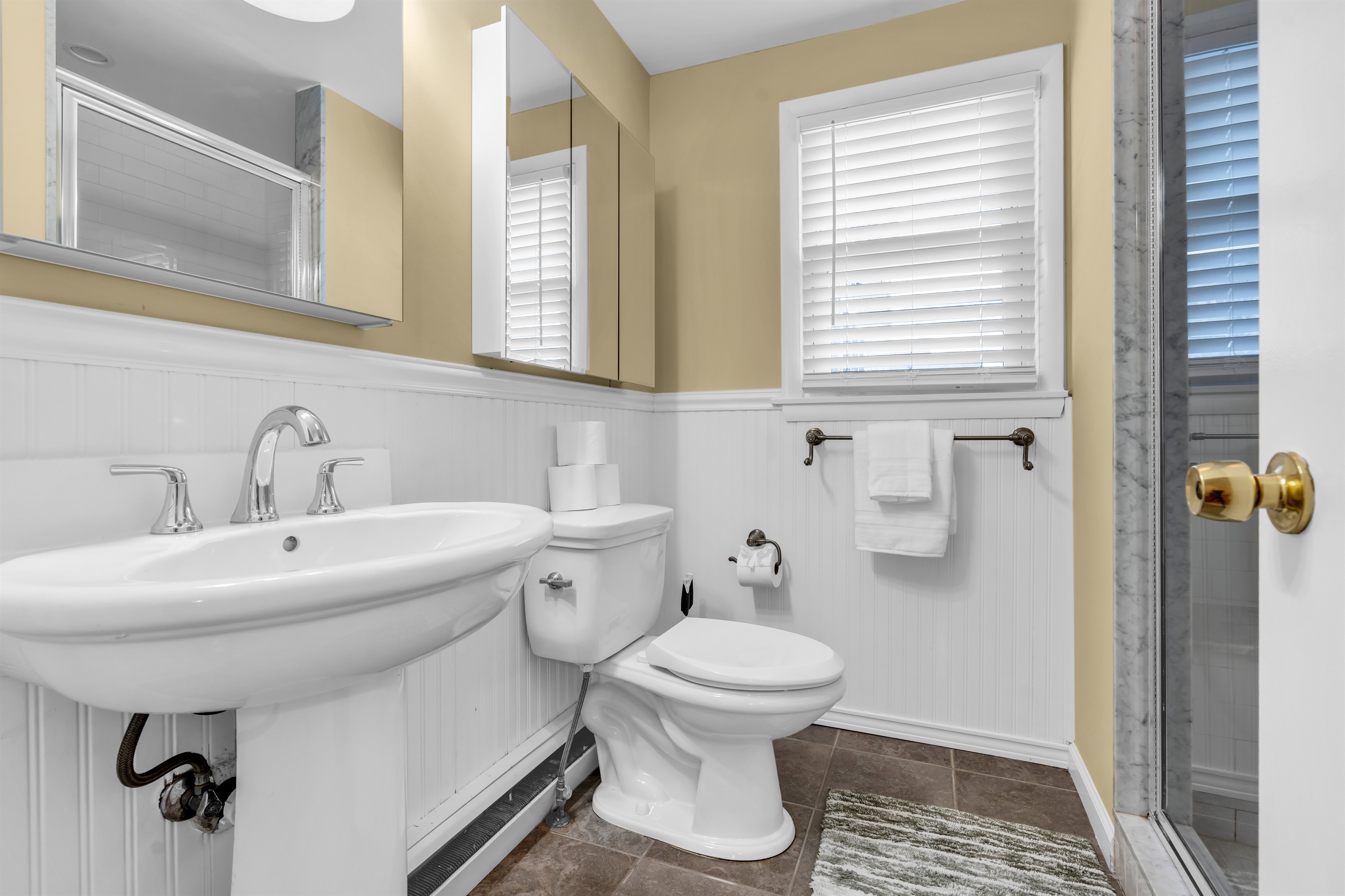 Master bathroom with tiled shower and generous amounts of toilet paper, shampoo, conditioner and body wash to make packing a breeze!