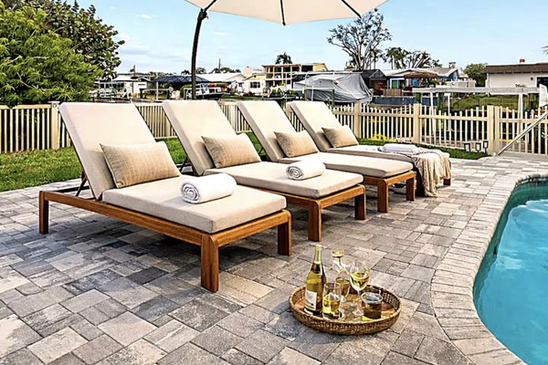Resort-style pool deck with luxury loungers overlooking the waterfront